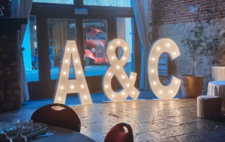 Light-up initials A and C in a reception hall