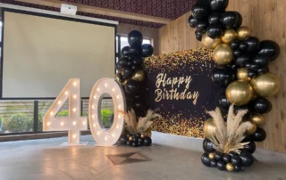 Light-up number 40 with black and gold balloons